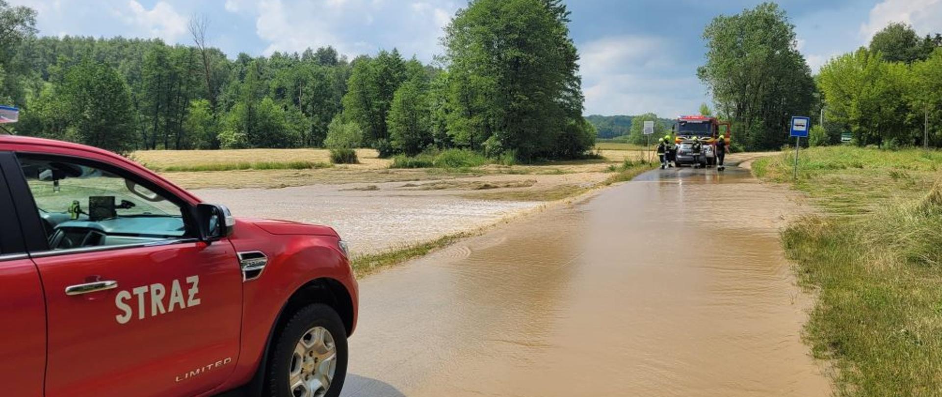 Zdjęcie przedstawia rozlewisko wody i zalaną drogę.