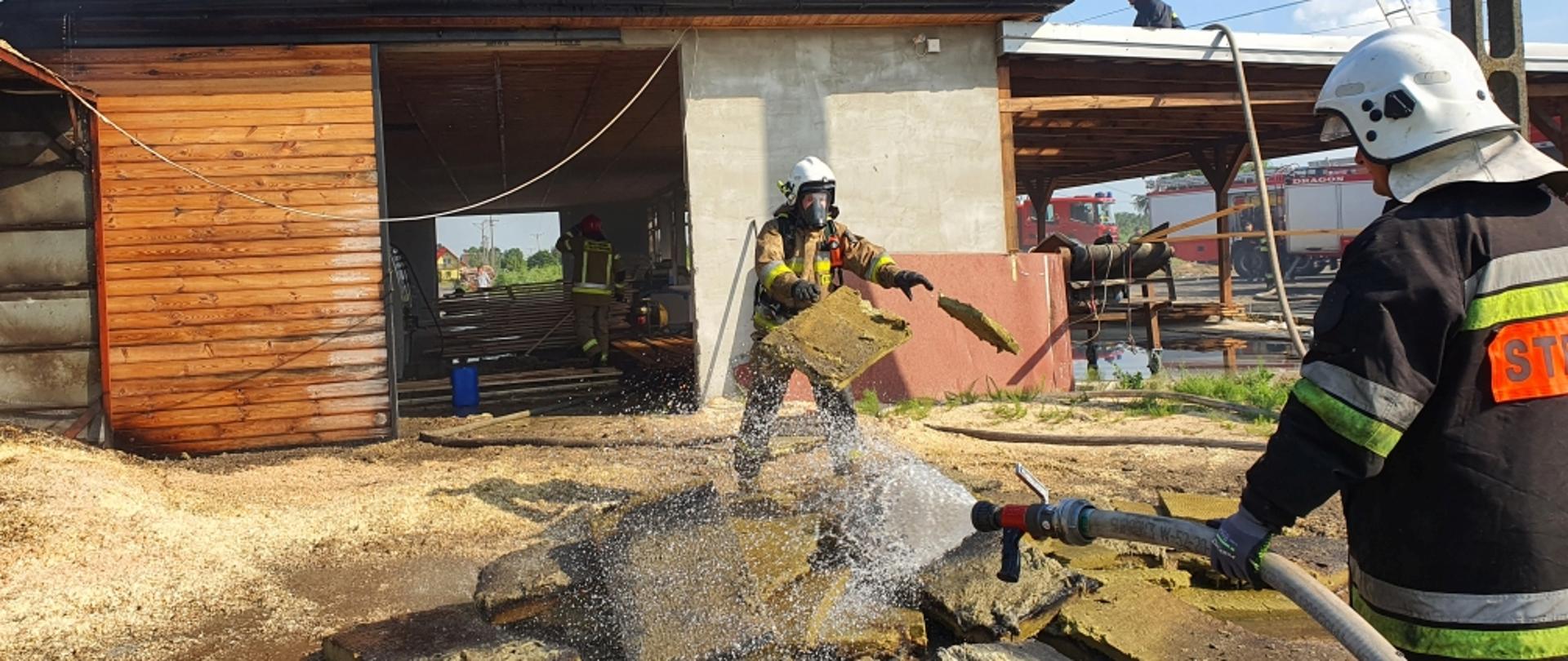 akcja gaszenia tartaku , na zdjęciu trzech strażaków