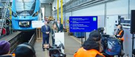 
In the photo: Minister Katarzyna Pełczyńska-Nałęcz in the railway depot with a train in the background