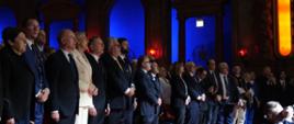 The presidential couple and the delegation sing the Polish national anthem