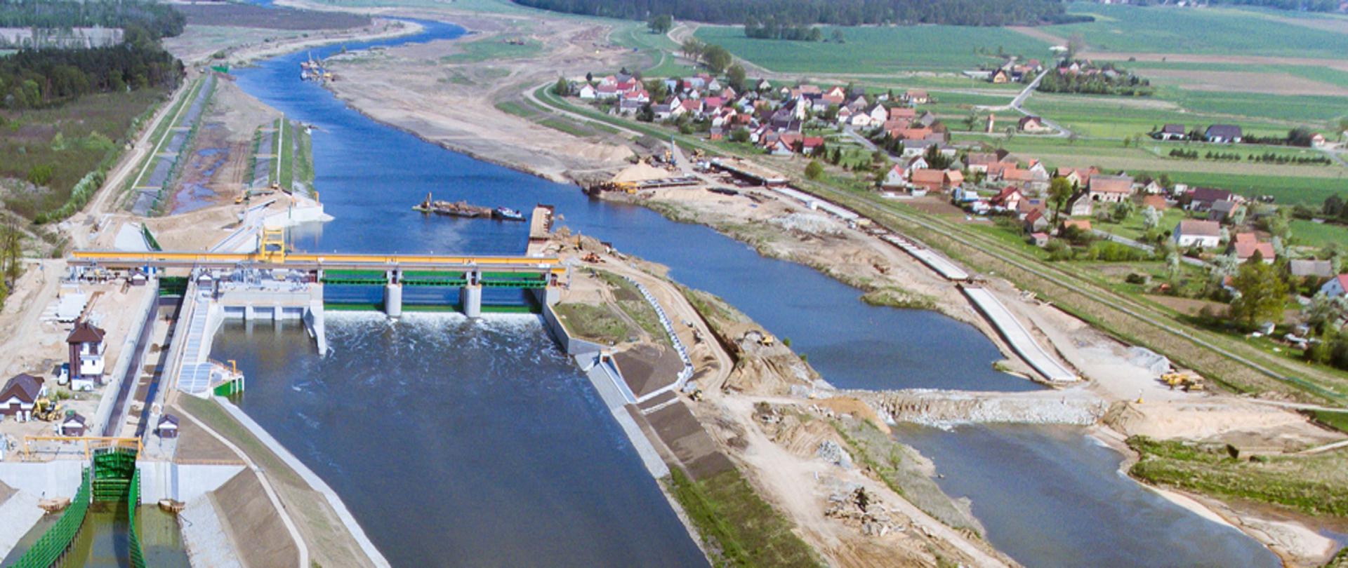 Zbiornik wodny z lotu ptaka. W oddali widać niedużą miejscowość.