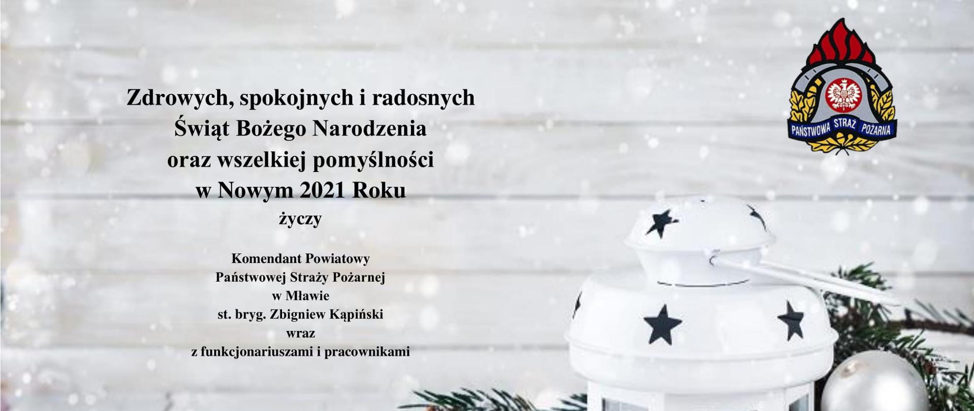 Na zdjęciu z lampionem świątecznym znajdują się życzenia świąteczne od Komendanta Powiatowego PSP w Mławie.