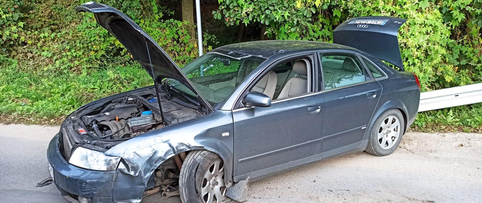 Zdjęcie przedstawia kolizje dwóch samochodów osobowych. Na zdjęciu widać uszkodzony samochód osobowy po kolizji. Zdjęcie wykonane w porze dziennej na drodze.