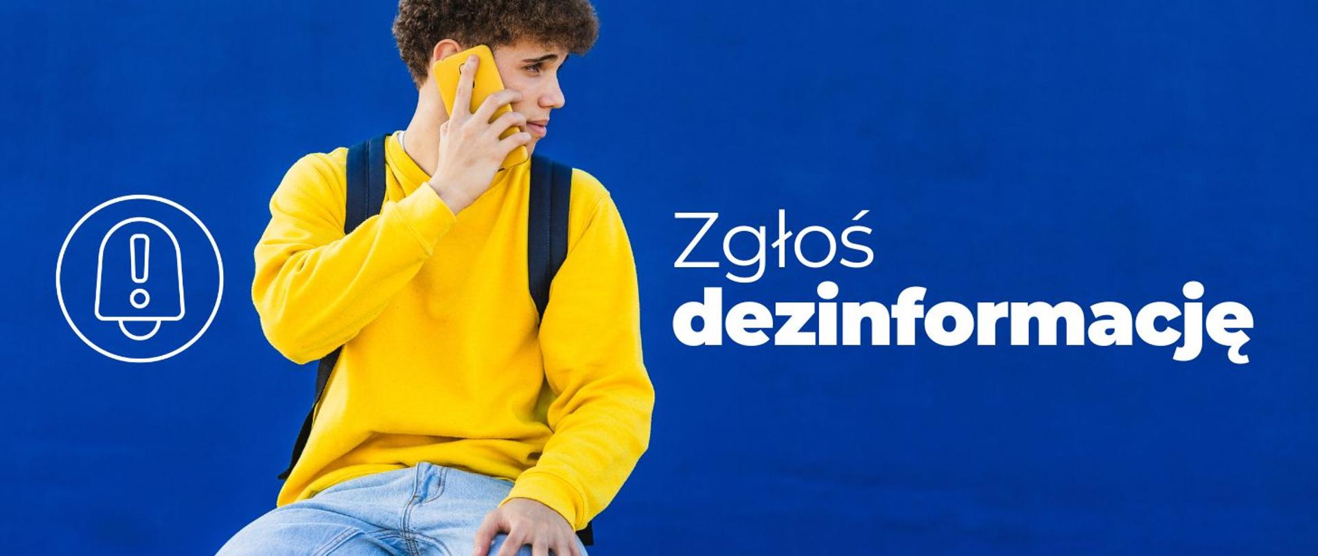 na zdjęciu widnieje młody mężczyzna w żółtej bluzie, rozmawiający przez telefon. Po prawej stronie widnieje napis: Zgłoś dezinformację. 