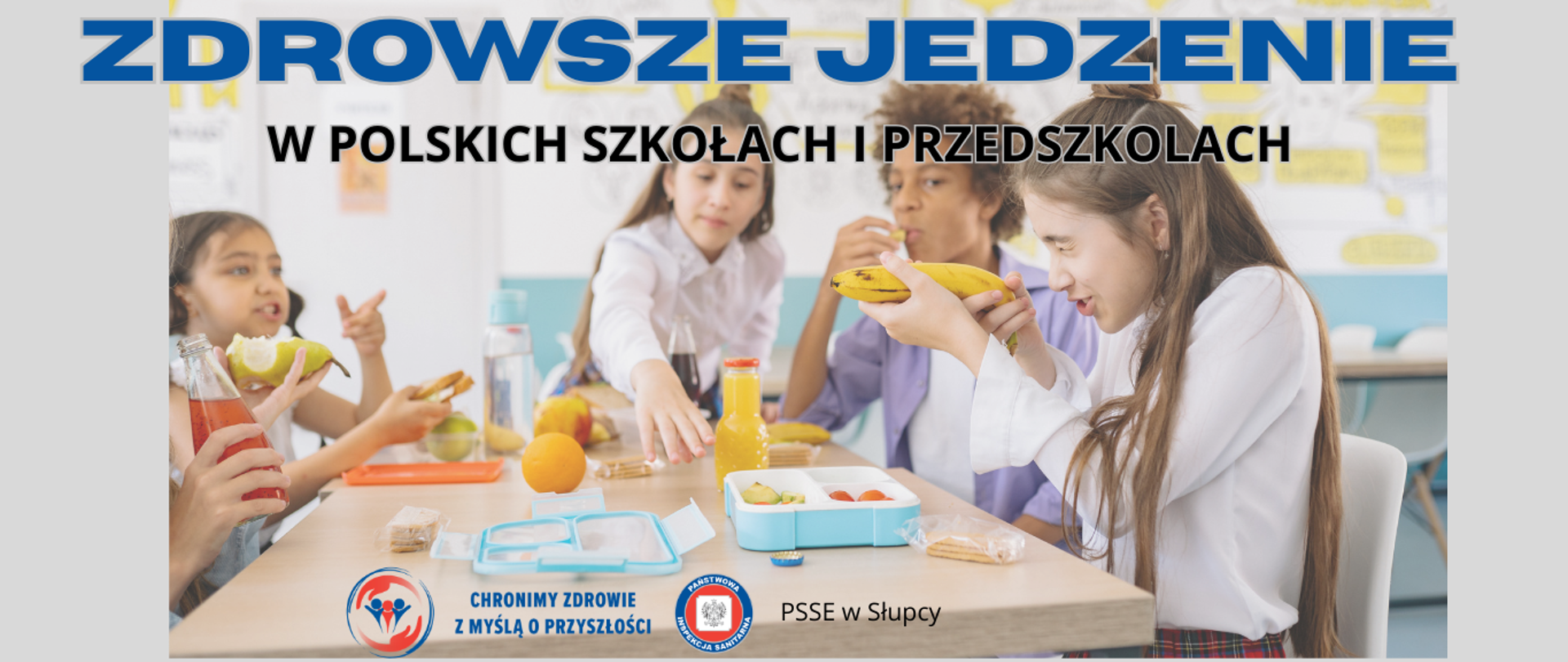 grupa dzieci na stołówce szkolnej siedzi przy stole i je zdrowe śniadanie 