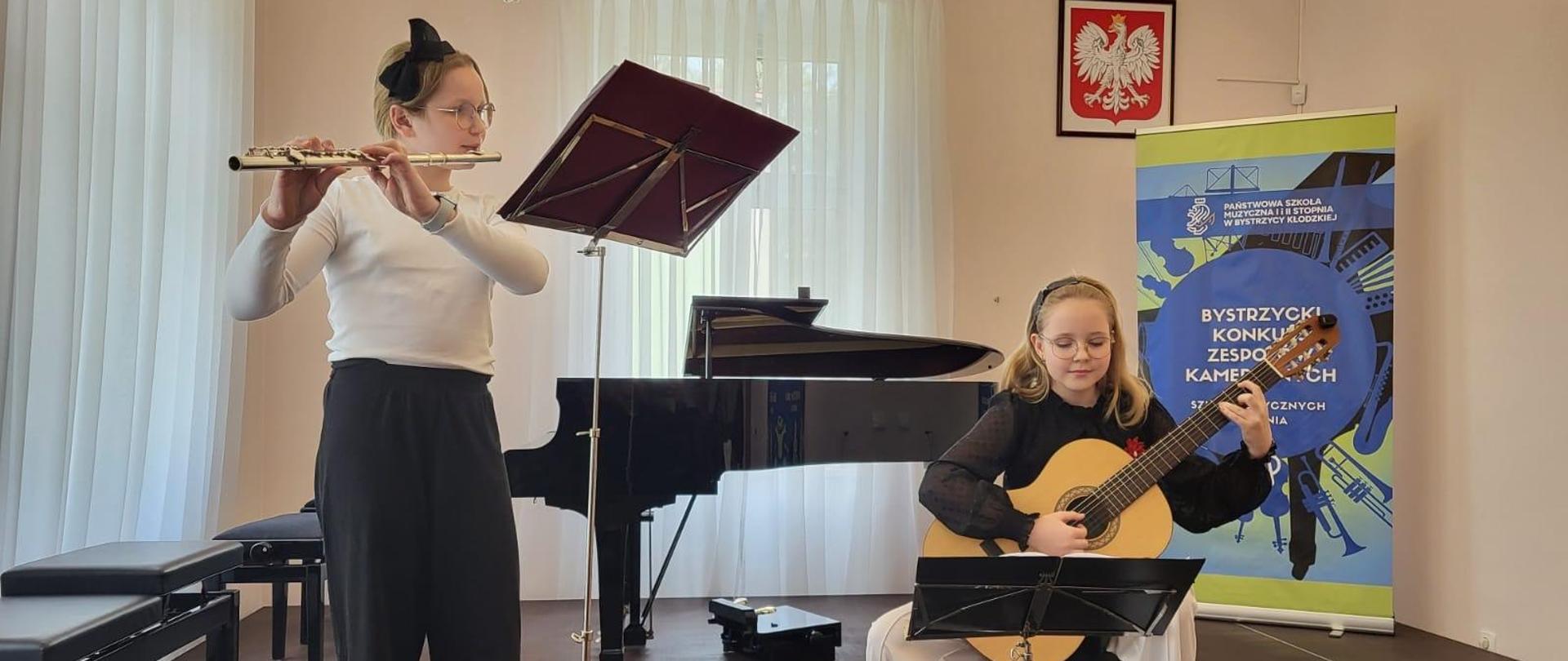 Od lewej uczennica gra na flecie, po prawej uczennica gra na gitarze na XXVII Bystrzyckim Konkursie Zespołów Kameralnych w Bystrzycy Kłodzkiej - 19 kwietnia 2024