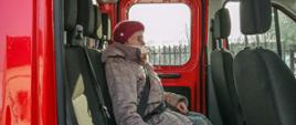 Starsza osoba w pojeździe OSP Bolimów podczas transportu na szczepienie.