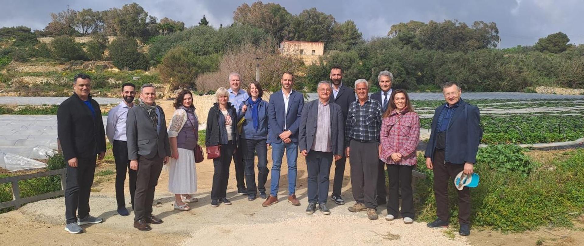 A group photo of the participants on a study trip to a farm that grows fruits and vegetables.