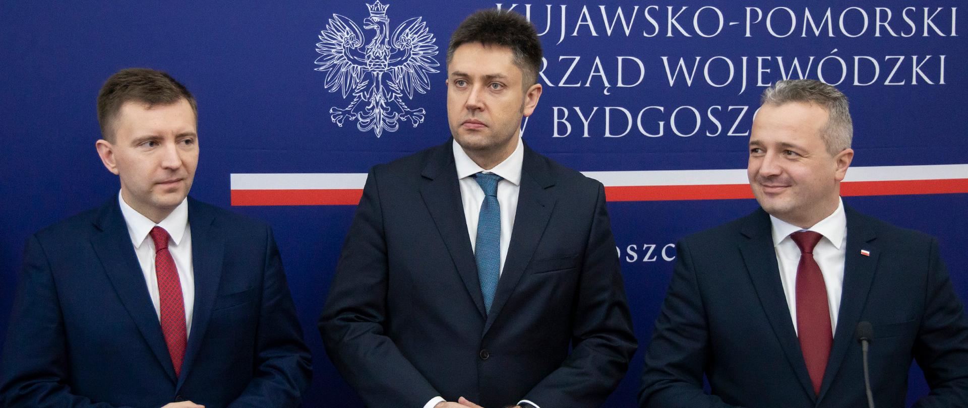 trzech mężczyzn w garniturach