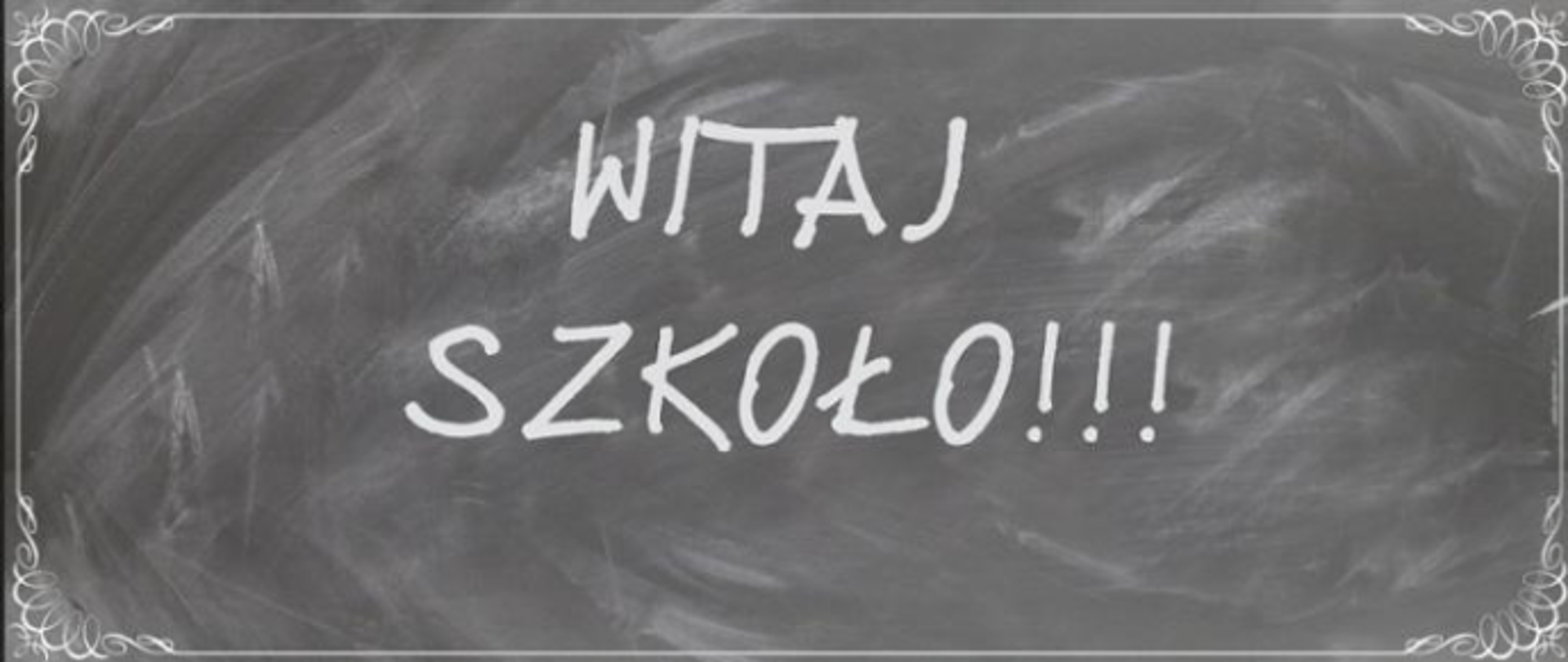 Biały napis "Witaj szkoło!!!" na szarym tle.