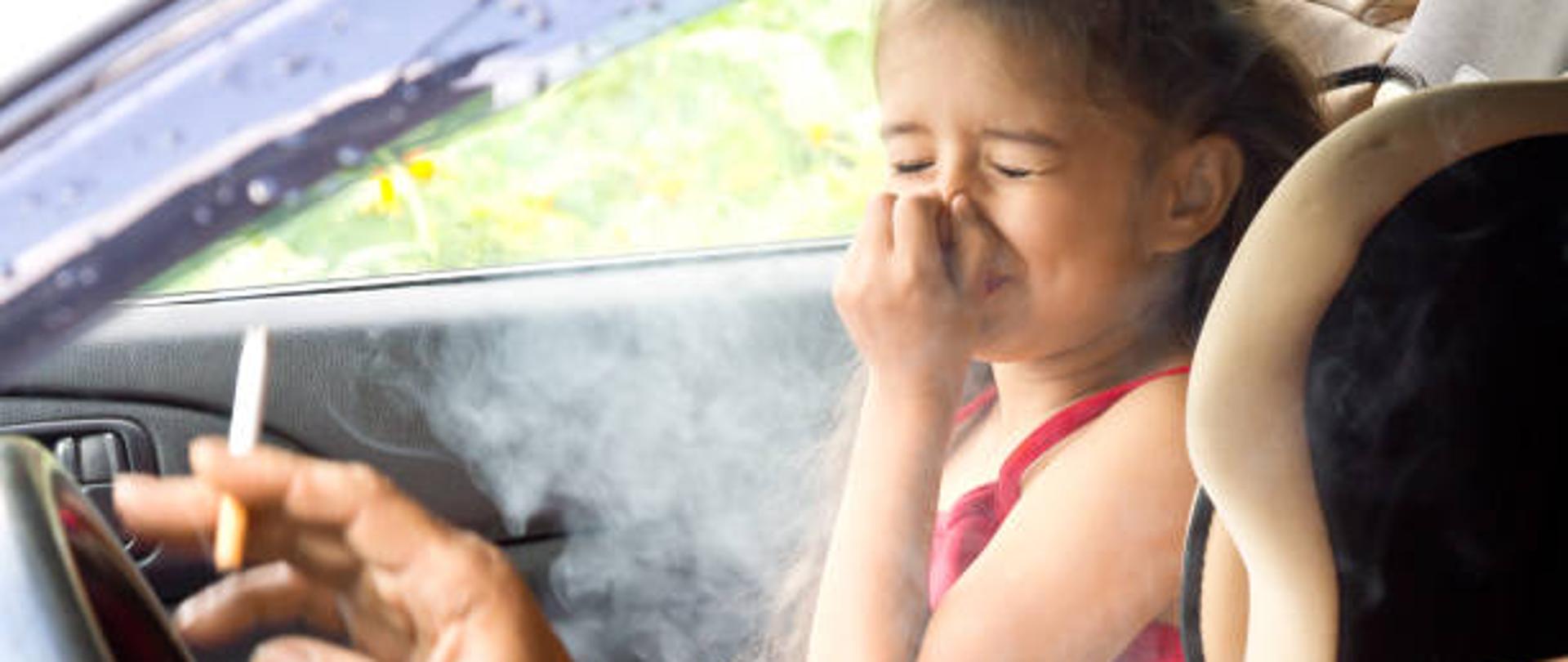 Stop smoking for children. Father smoking cigarette and the child choking of smoke in a car