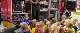 Strażacy omawiają i pokazują dzieciom sprzęt pożarniczy