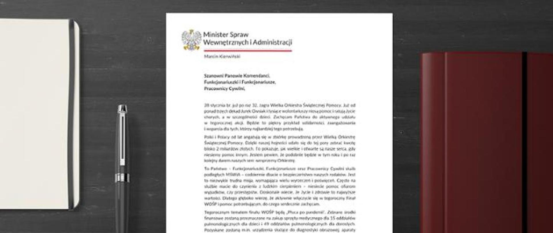 List pana ministra Marcina Kierwińskiego do funkcjonariuszy służb podległych MSWiA na tle biurka na którym znajduje się organizer, teczka oraz pióro