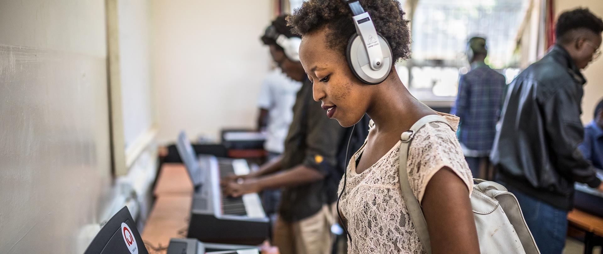 Gloria Kamau making music with the new pianos donated by the Polish Aid at Kenyatta University.