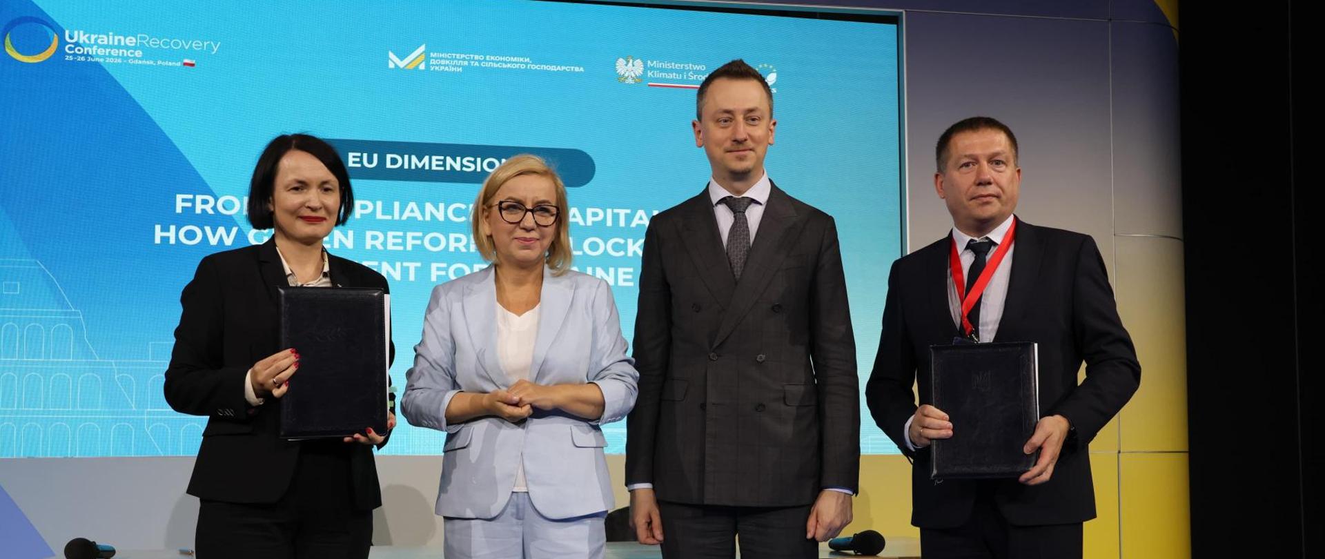 Minister of Climate and Environment Paulina Hennig-Kloska at the international Ukraine Recovery Conference. The photograph shows the Minister standing with three other participants and posing for a group photo.