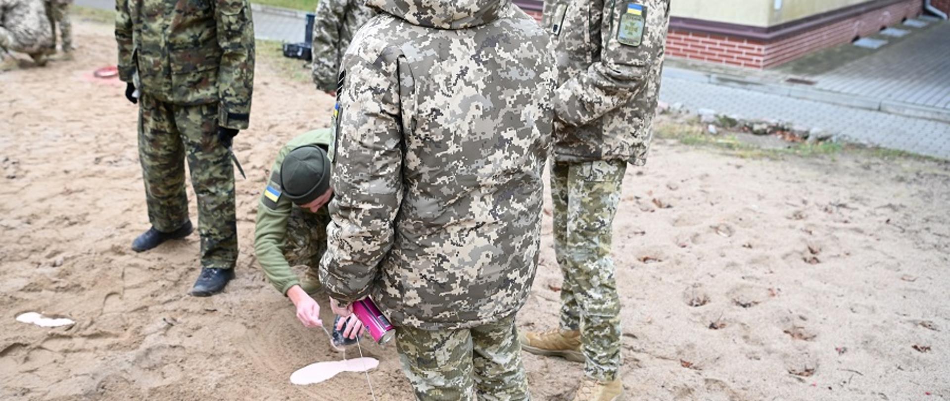 Grupa polskich i ukraińskich funkcjonariuszy w mundurach uczy się zabezpieczania śladów