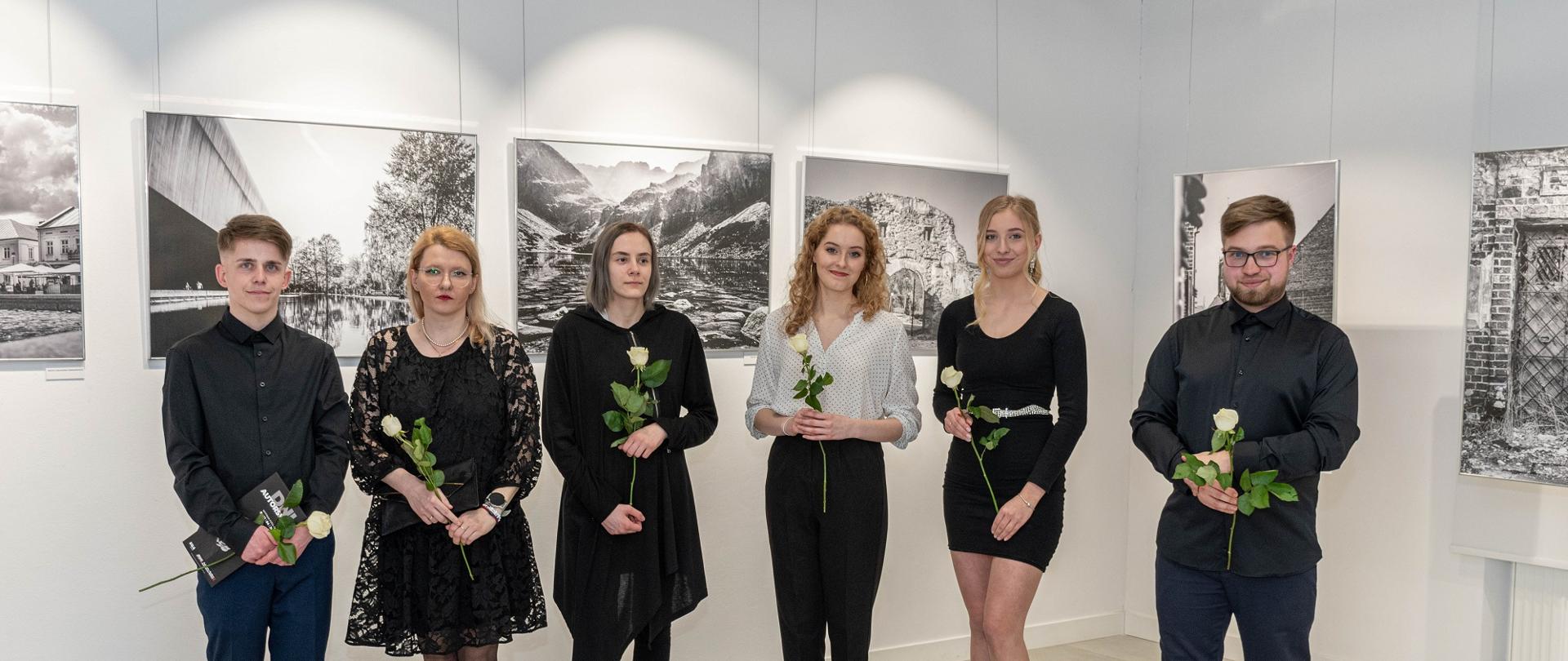 Wernisaż wystawy fotograficznej Dni Autorskie. Na zdjęciu stoją słuchacze studium, którzy są autorami wystawy. Na ścianach wiszą podświetlone zdjęcia-prace słuchaczy studium.