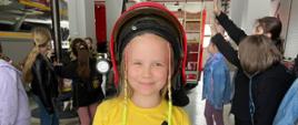 Dziewczynka przymierza hełm strażacki