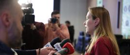 Na zdjęciu Minister Katarzyna Pełczyńska-Nałęcz przed mikrofonami odpowiada na pytania dziennikarzy