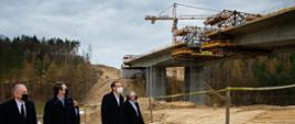 Premier i ministrowie zwiedzają budowę.