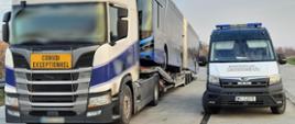 Od lewej: ciągnik siodłowy z naczepą, na której jest przewożony autobus przegubowy. Obok stoi oznakowany furgon mazowieckiej Inspekcji Transportu Drogowego.