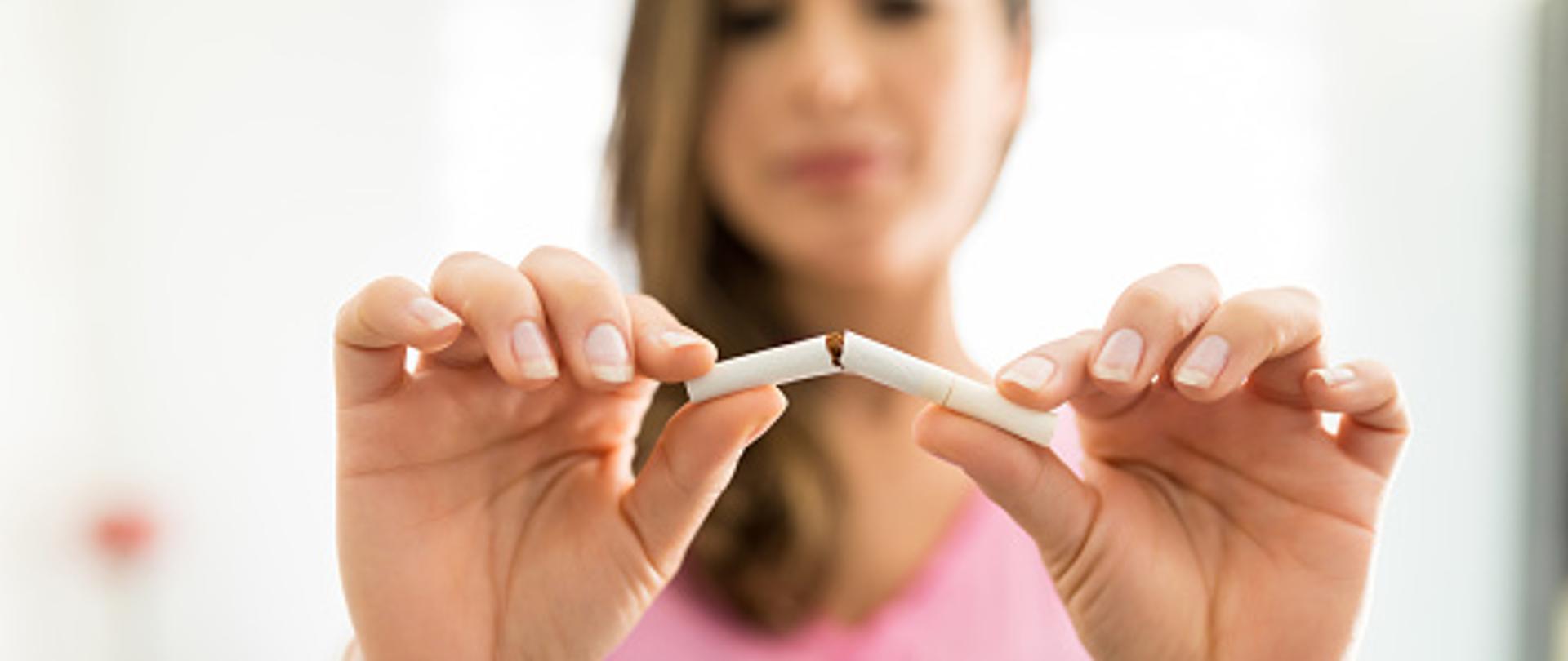Closeup of woman's hands breaking cigarette to fight addiction