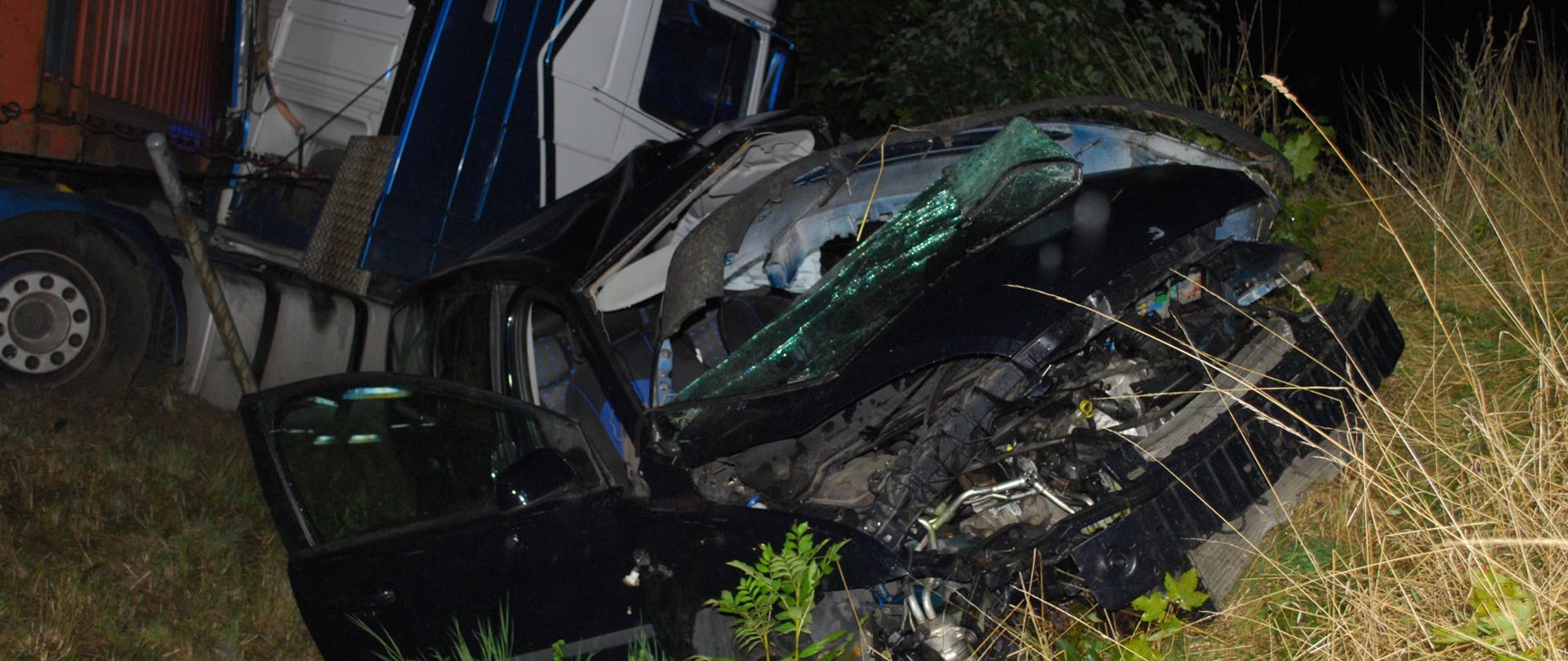 Na pierwszym planie rozbity samochód Ford Focus, w tle rozbita ciężarówka marki DAF