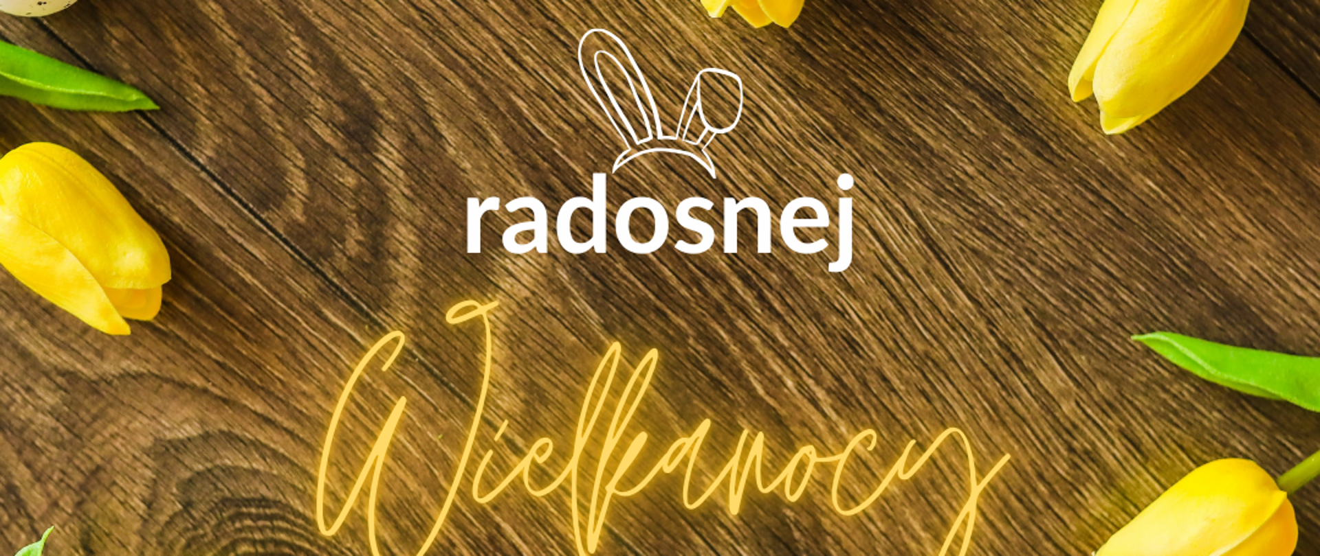 Żółtego koloru tulipany a na środku biały napis radosnej a żółty Wielkanocy