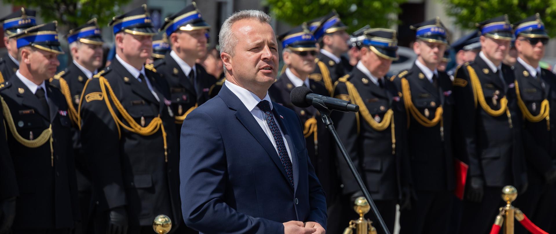 Jeden mężczyzna stojący przy mikrofonie i wypowiadający się