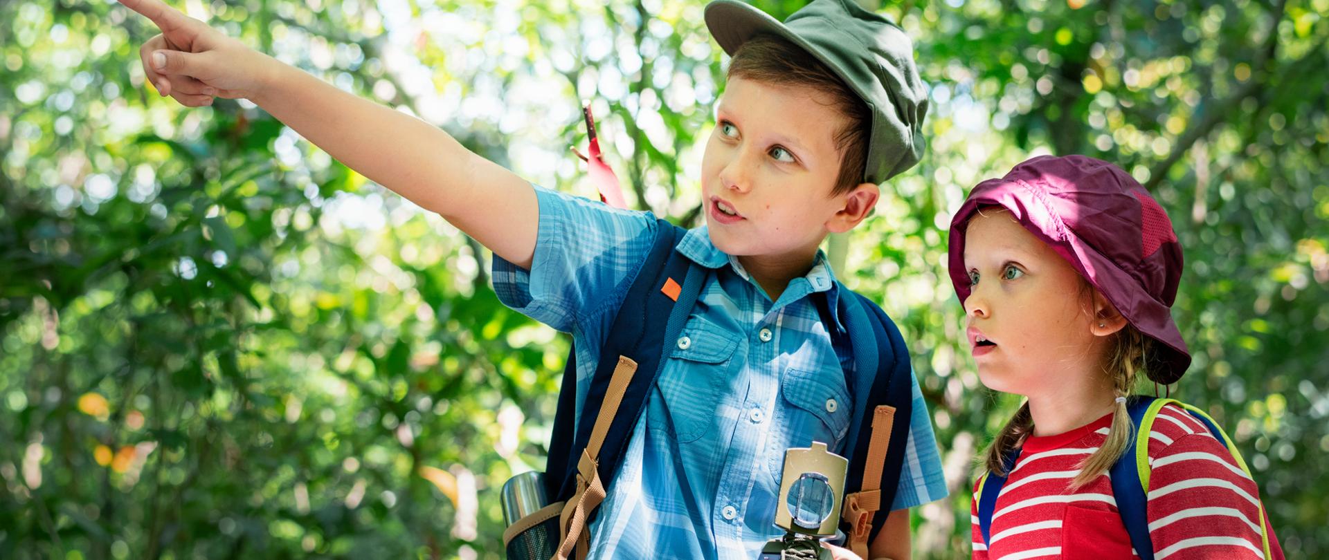 Two cute kids trekking in the forest