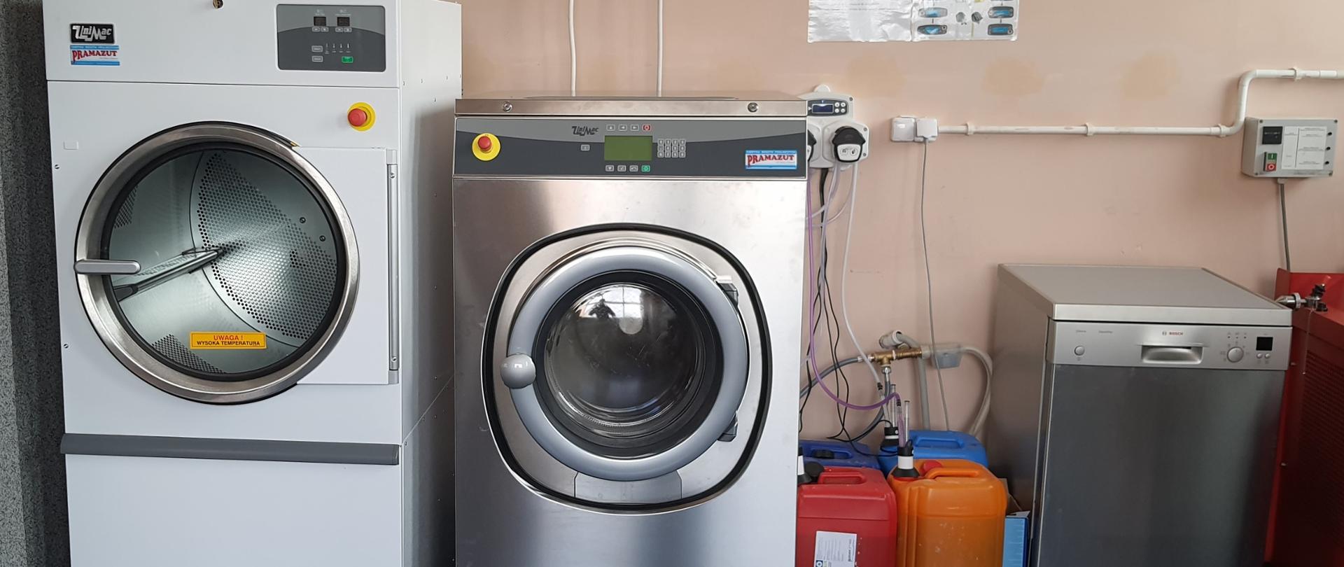 na zdjęciu widoczna pralka oraz suszarka do prania, z bok ustoi zmywarka i cztery plastikowe karnistry