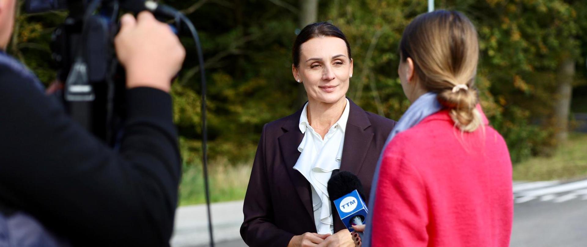 wojewoda udziela wywiadu stojąc na nowej drodze w Gościcinie