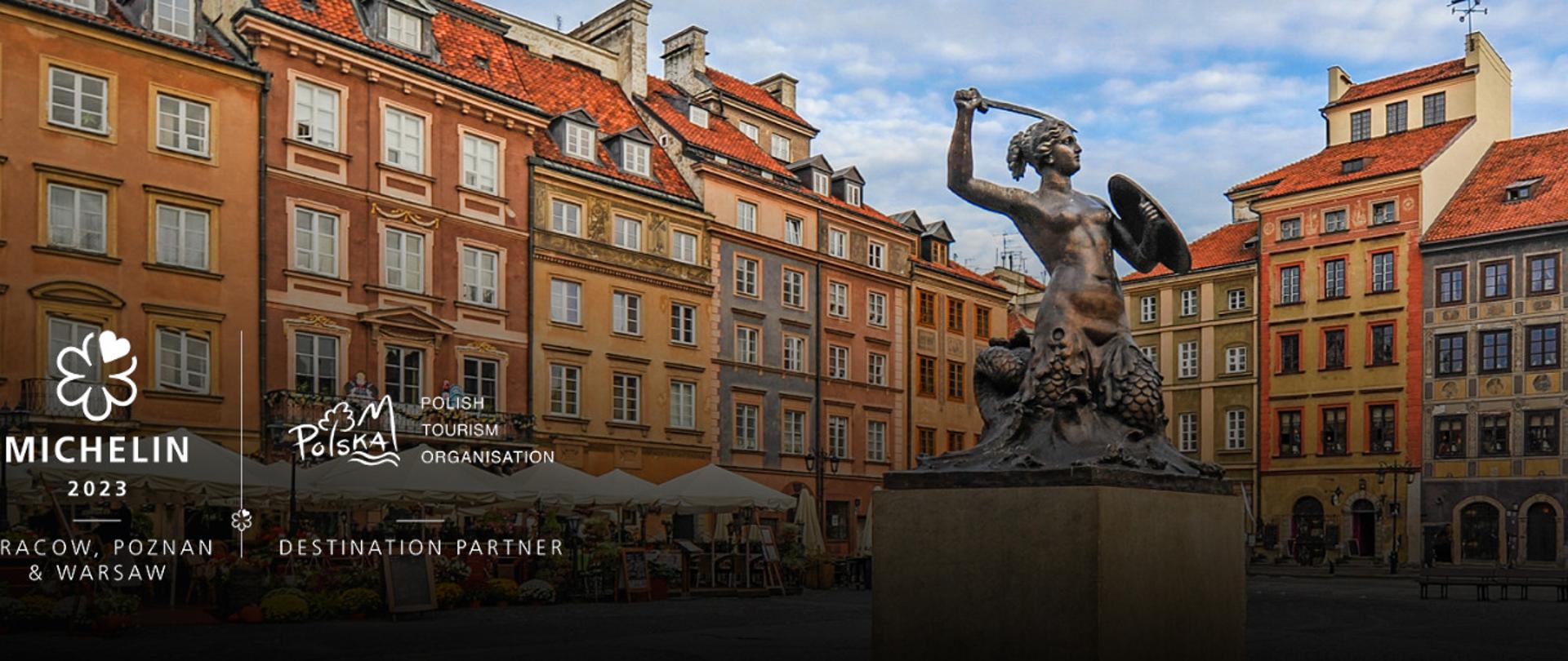 Zdjęcie przedstawia syrenkę warszawską na Starym Mieście, która w jednej ręce trzyma tarczę, a w drugiej miecz. Grafika przedstawia również kolorowe kamieniczki Starego Miasta. W dolnym lewym rogu znajdują się logotypy: Michelin 2023 oraz Polskiej Organizacji Turystycznej.