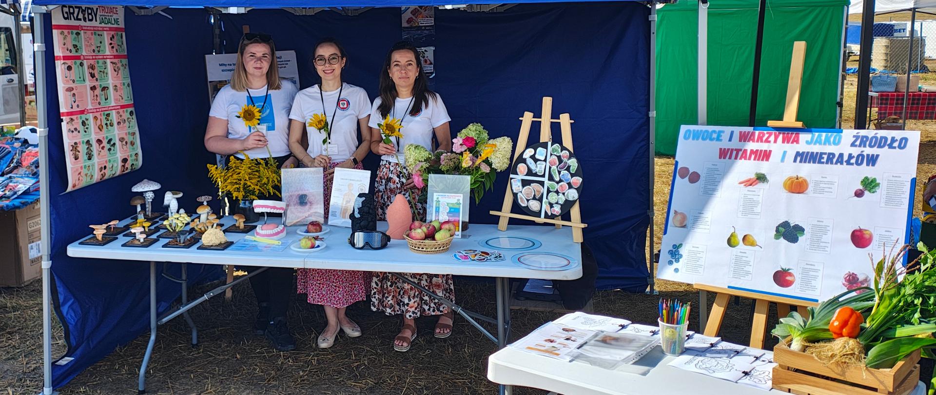 Zdjęcie przedstawia pracowników Inspekcji Sanitarnej, którzy podczas dożynek w Olszówce, gmina Golub- Dobrzyń promują zdrowy styl życia i zdrowe odżywianie.