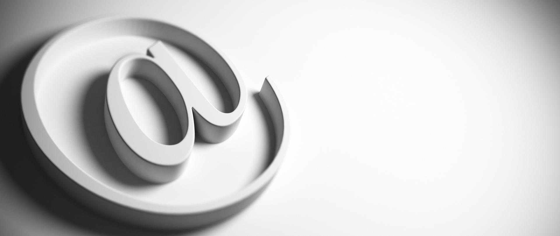 email symbol, at sign, grey background, panoramic image blur effect and copy space on the right, 3D render