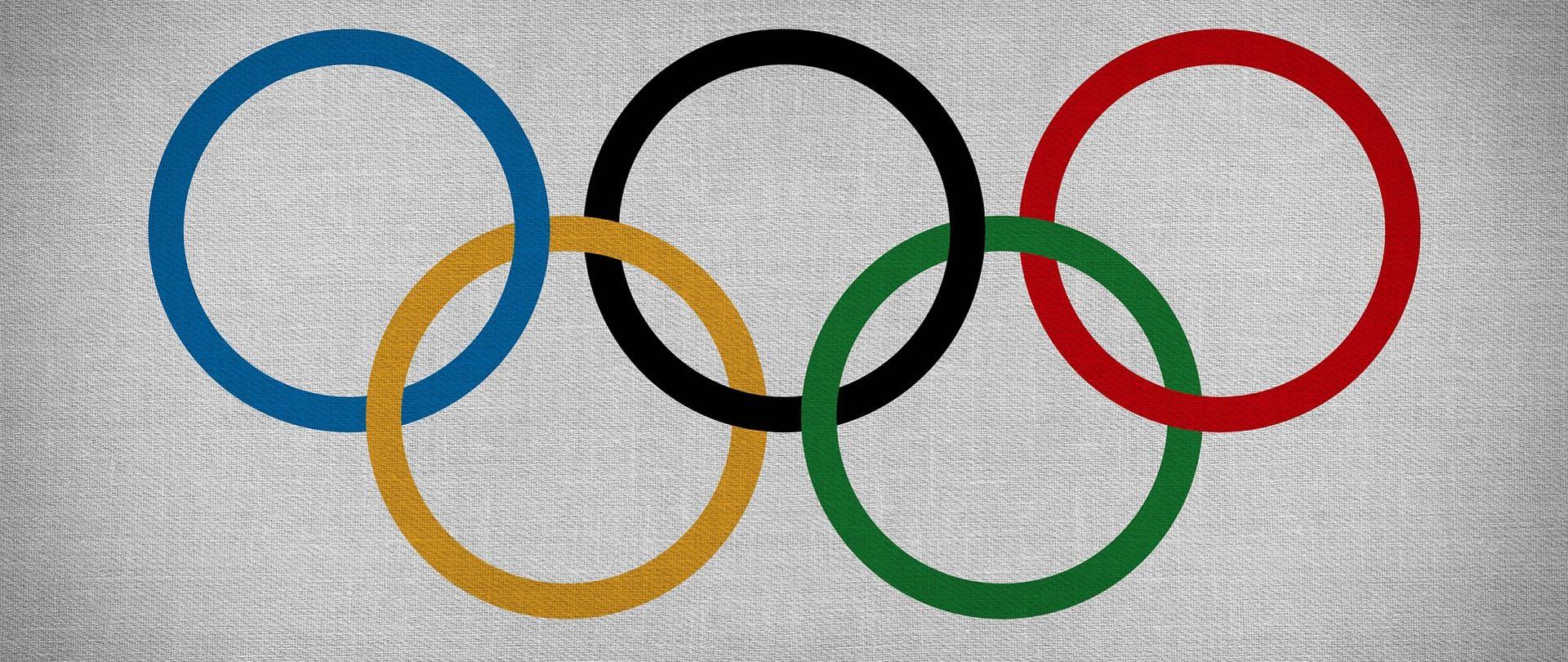 Symbole olimpiady - przeplatające się kolorowe koła.