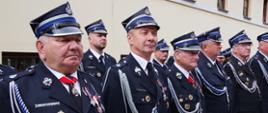 Widok z przodu. Zasłużeni członkowie ochotniczych straży pożarnych w szeregu. 
